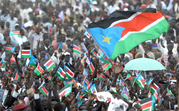 The South Sudanese flag waves above a crowd