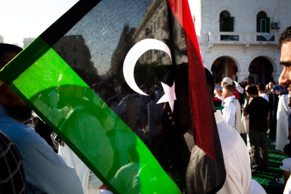 The Libyan flag is seen among a crowd