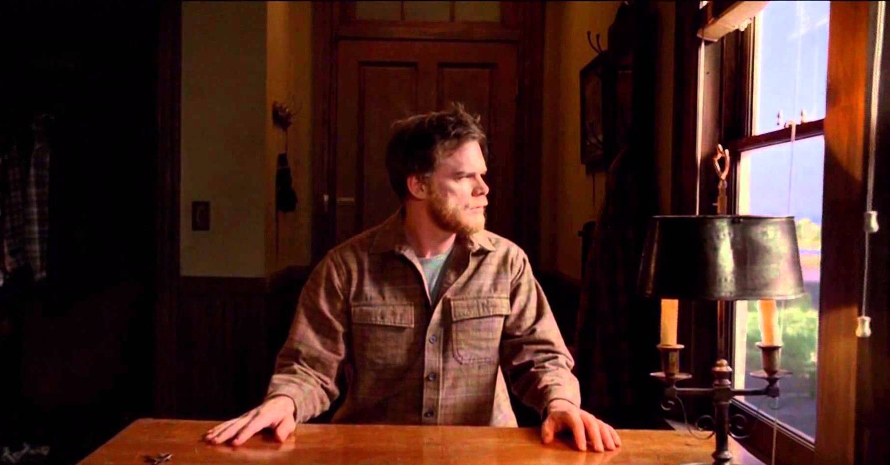 Michael C. Hall as Dexter Morgan sitting at a table in a jumpsuit in the series finale of Dexter