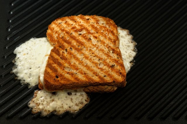 Grilled cheese frying on a griddle