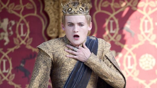 Jack Gleeson is reaching for his neck as he is choking in Game of Thrones.