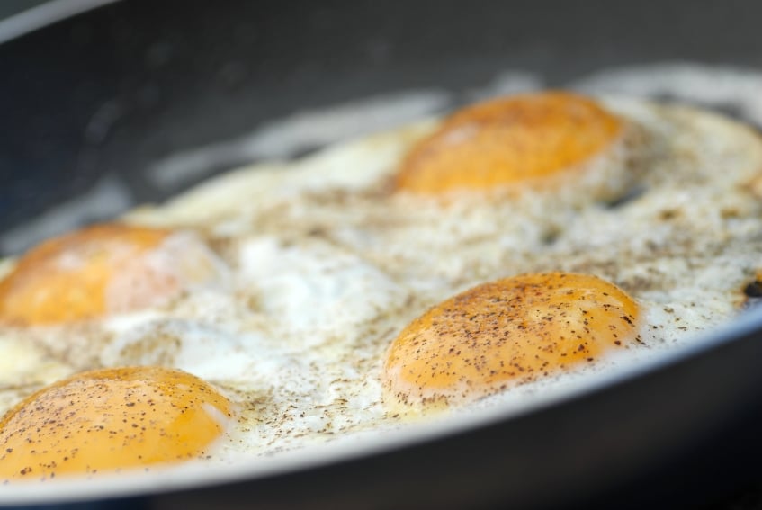 frying eggs in a skillet