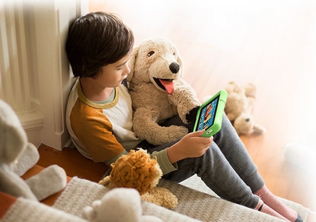 kid reading to stuffed dog