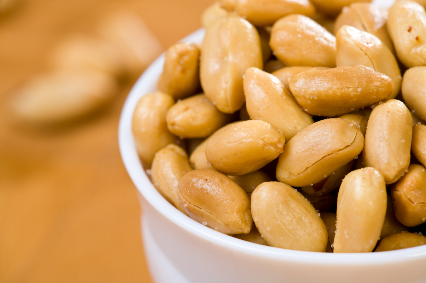 shelled peanuts in a white bowl