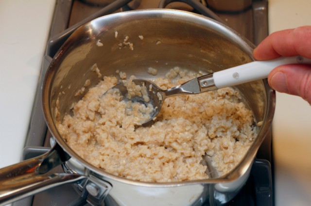 stirring oatmeal in a pot