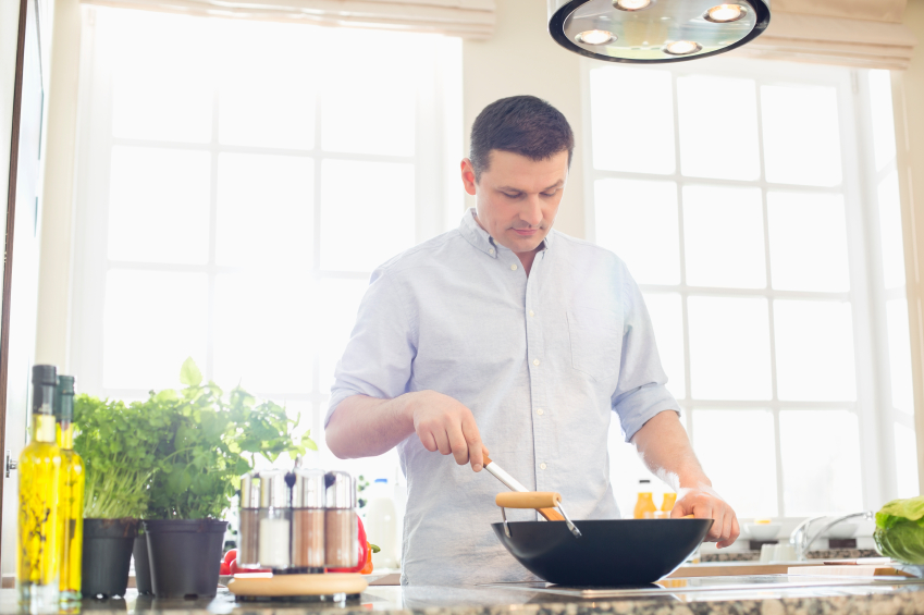 A man prepares food in the kitchen