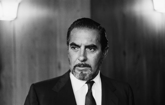 Tyrone Power looking serious in a suit and tie