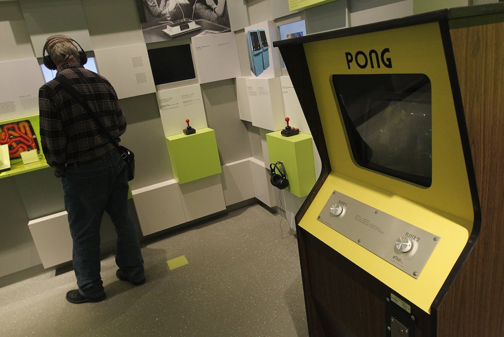  A visitor listens to an audio presentation next to a standing console of Pong, one of the earliest, commercially successful video games, at the Computer Game Museum (Computerspielemuseum) on January 26, 2011 in Berlin, Germany. The museum, which opened January 21, traces the evloution of computer games through approximately 300 exhibits. (Photo by Sean Gallup/Getty Images)