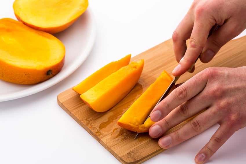 Mango Slice Being Cut Into Four Fruit Chips