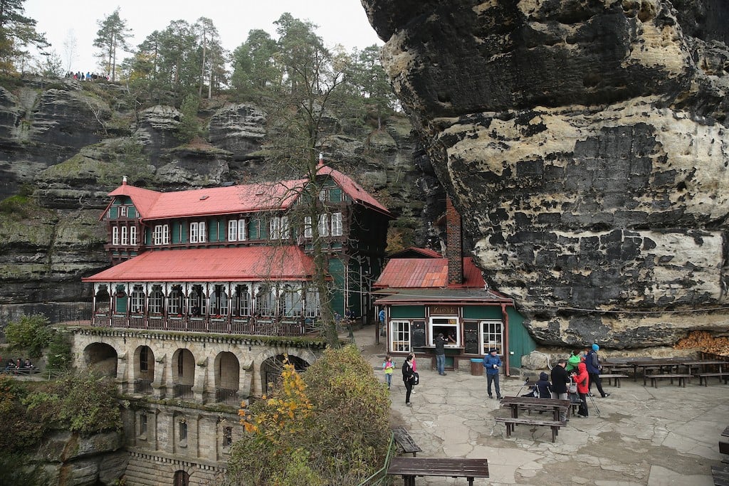 A wooden palace called Falcon's Nest, which today houses a pub frequented by hikers, stands in the Pravcicka Brana rock formation in an area known as Czech Switzerland (Ceske Svycarsko) on October 26, 2014 near Hrensko, Czech Republic. Ceske Svycarsko, located in northern Bohemia along the Elbe River near the border to Germany, is a popular tourist destination and is known for its dramatic rock formations, hiking and rock climbing. (Photo by Sean Gallup/Getty Images)