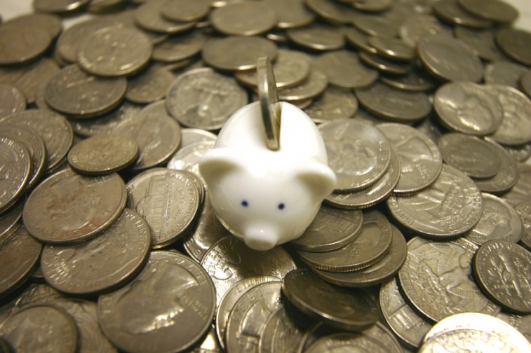 Pile of change with a piggy bank in the middle