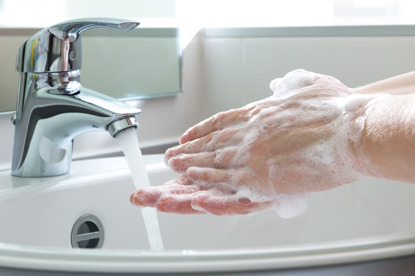 A person washes their hands