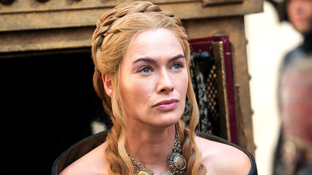 Cersei Lannister, her hair long and in braids, looks pensive in a scene from 'Game of Thrones.'