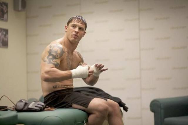 Tom Hardy bandages his hand while preparing to fight in Warrior
