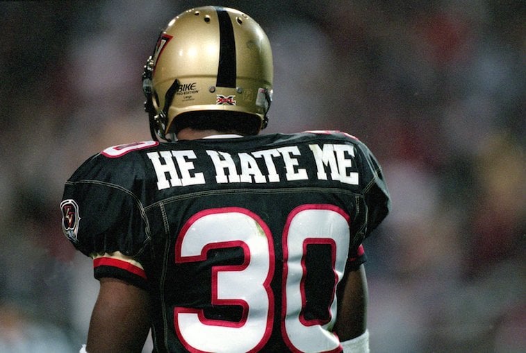 A football player shows the back of his jersey which reads "He Hate Me' above the number 30 in X.F.L.