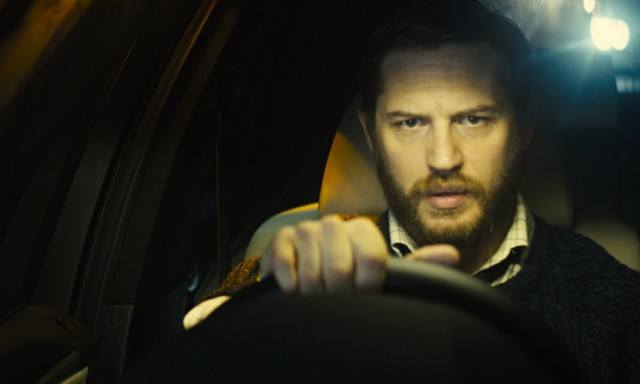 Tom Hardy holds on to the starring wheel of a car