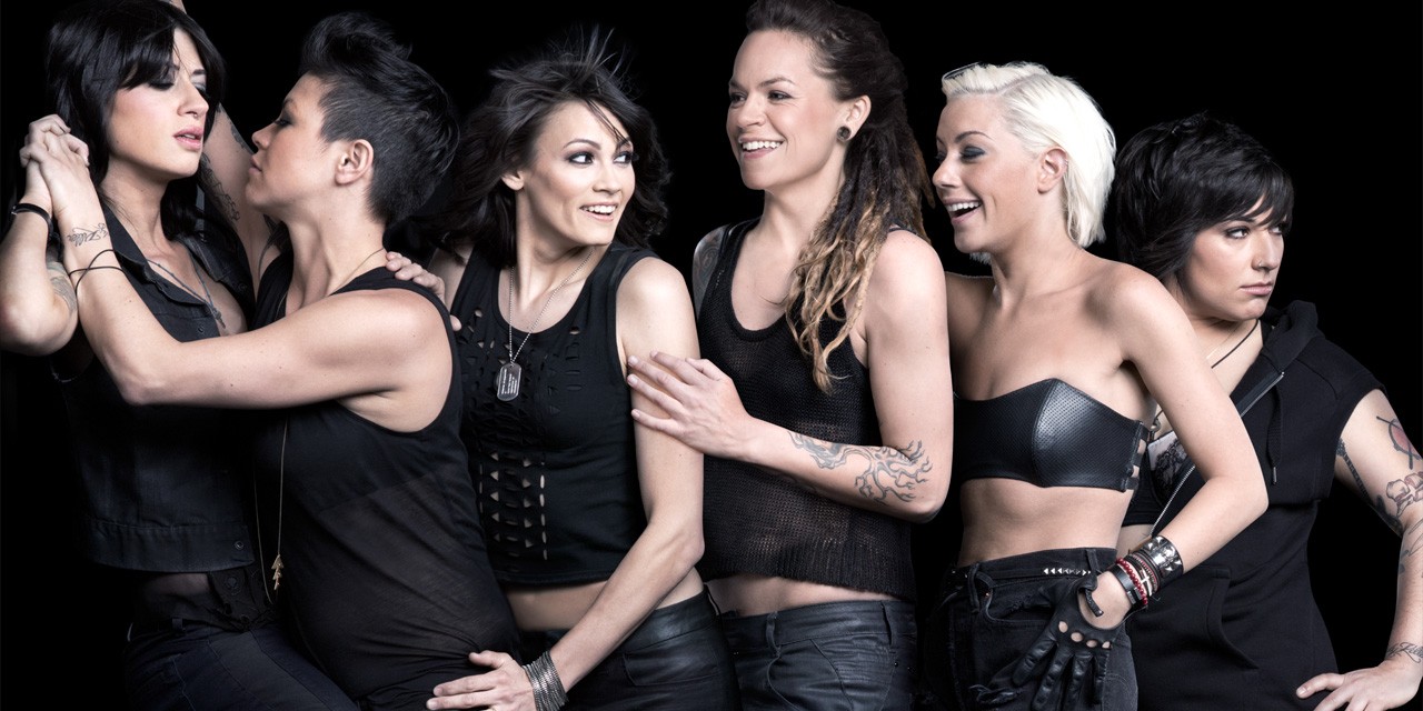 The cast of the L Word, clad in black and smiling together in a promo photo