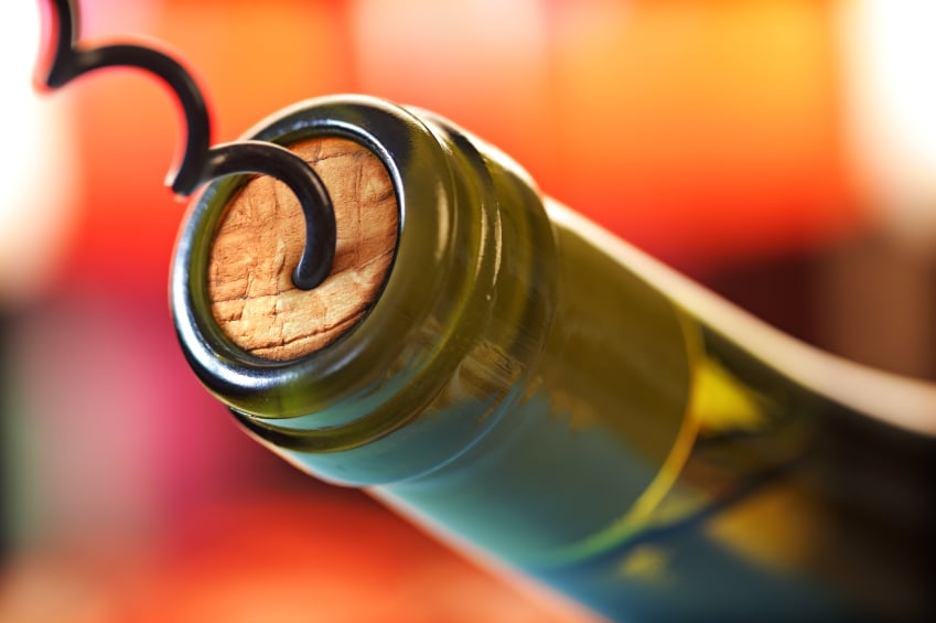 corkscrew opening a bottle of wine