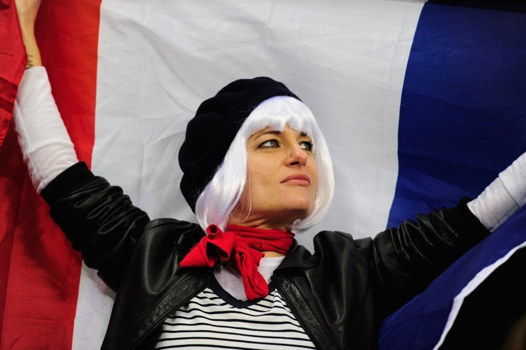 A woman holds the French flag.