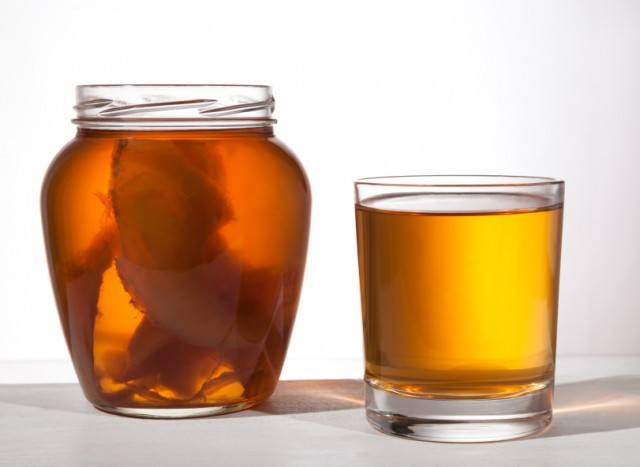 Jar and glass of kombucha