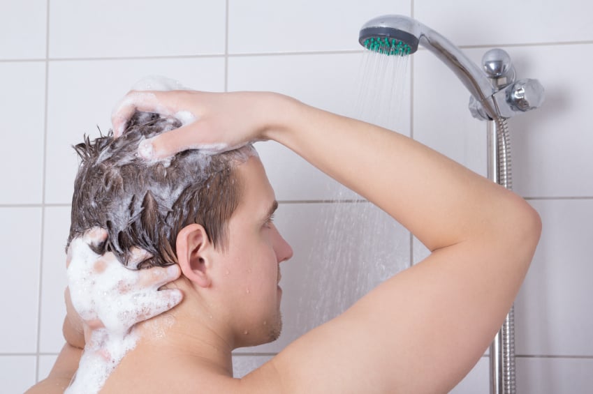 man washing hair in shower