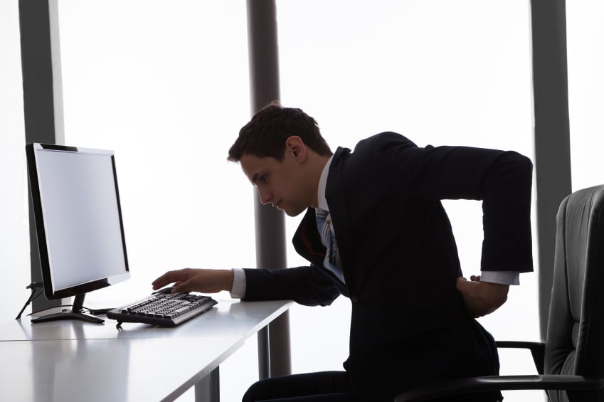 Businessman Suffering From Backache In Office