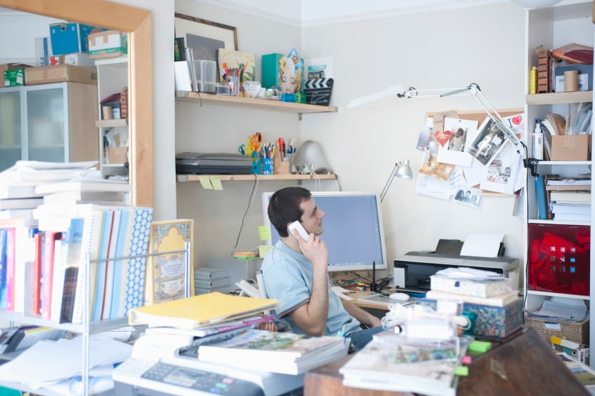 man on phone in his home office 