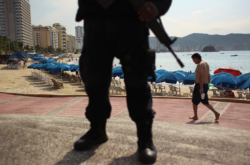 man with gun in Acapulco, Mexico