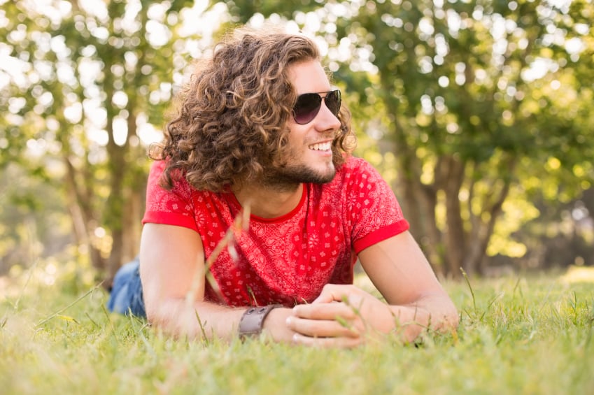 man with curly hair in the park