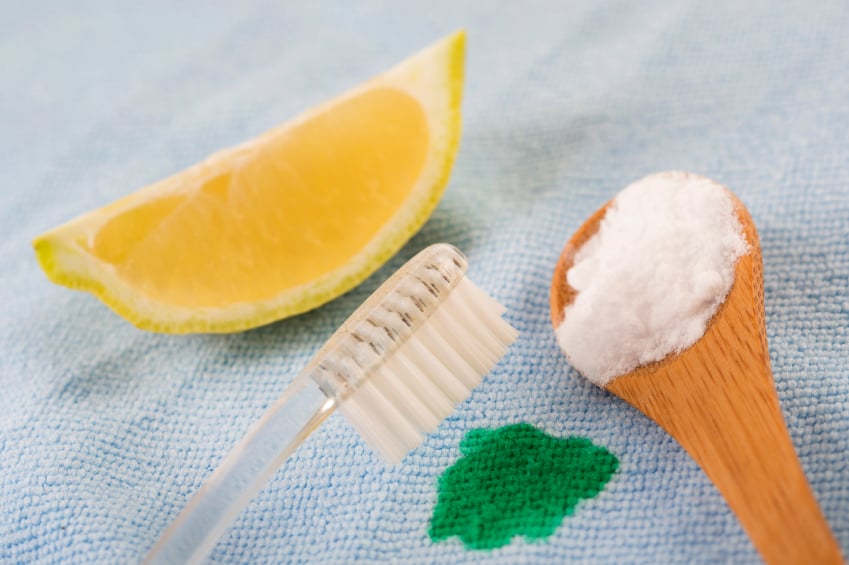 lemon, baking soda, and toothbrush with stain