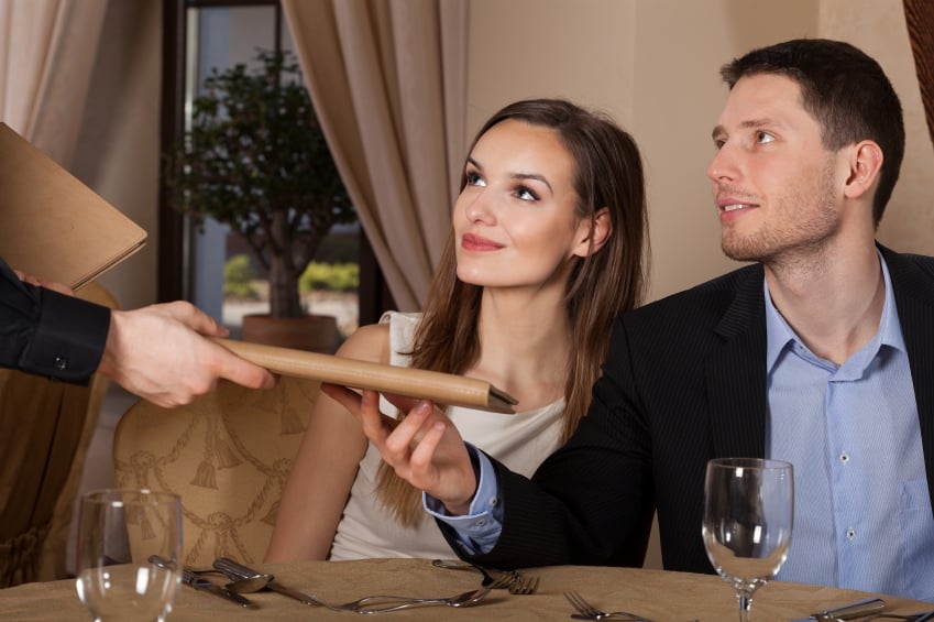 couple receiving menus in a restaurant 