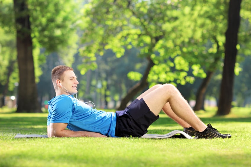 man laying on a mat outside