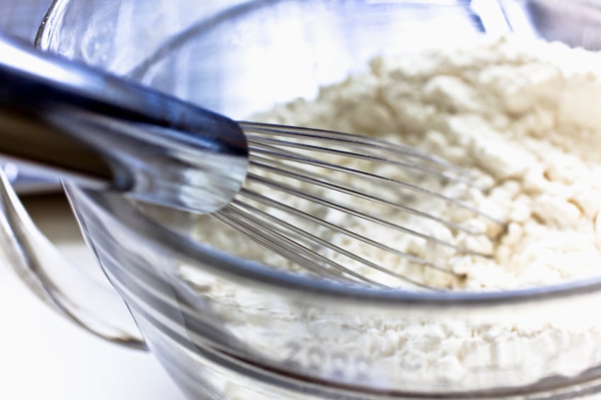 bowl of flour with whisk