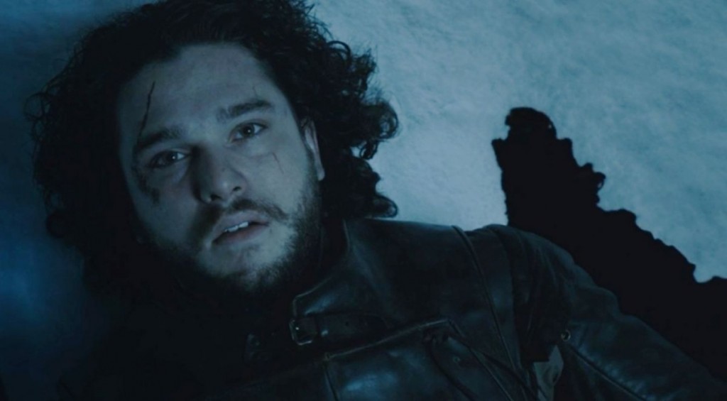Jon Snow is lying in the snow dead and surrounded by blood.
