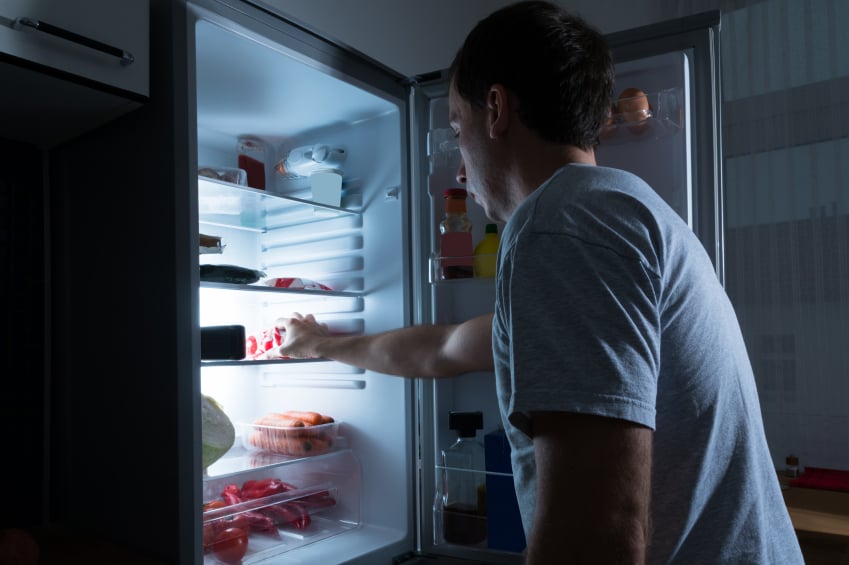 Man going for a late-night snack in the fridge