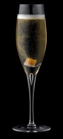 Glass of champagne and brandy, with sugar cube, close-up