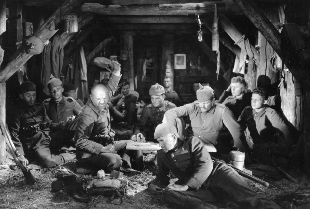 A group of soldiers sit together in what appears to be a mine-shaft