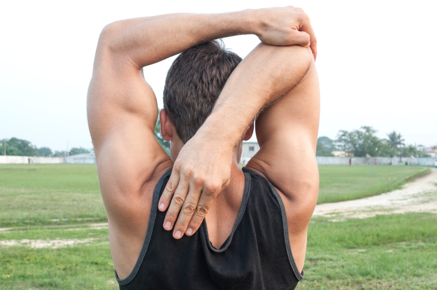 A man stretching his triceps after a workout A man stretching his triceps after a workout