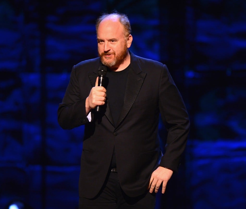 Louis CK performs on stage