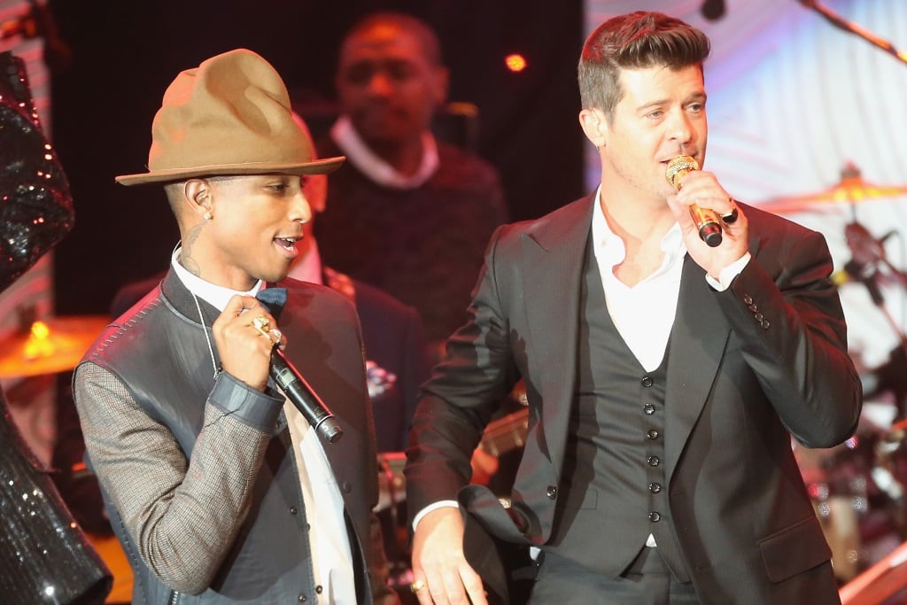 Pharrell Williams and Robin Thicke are singing on stage.