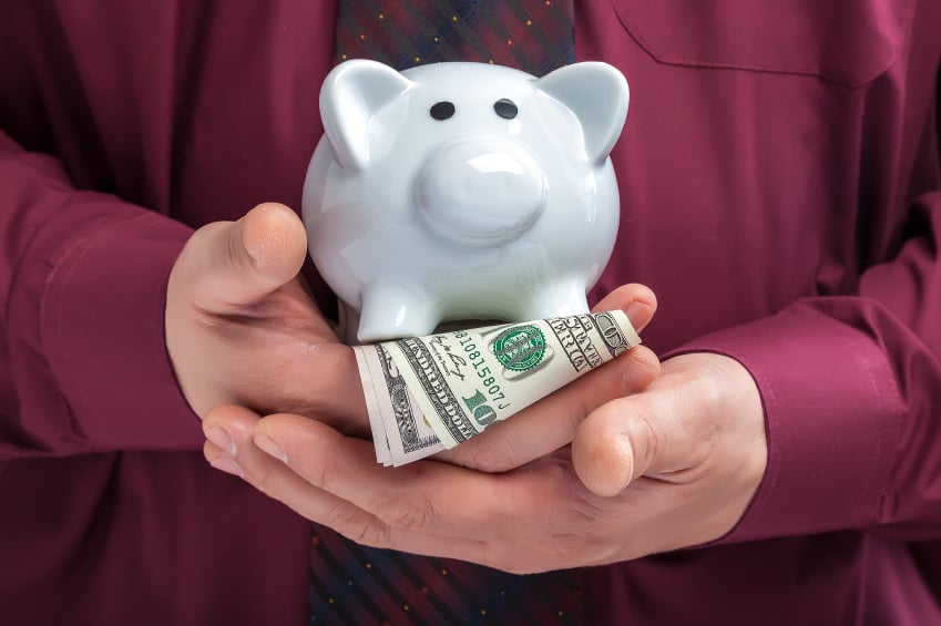man holding money and piggy bank