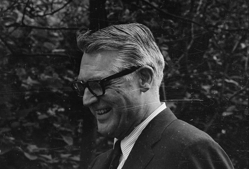 Actor Cary Grant is wearing glasses in a black and white photo.