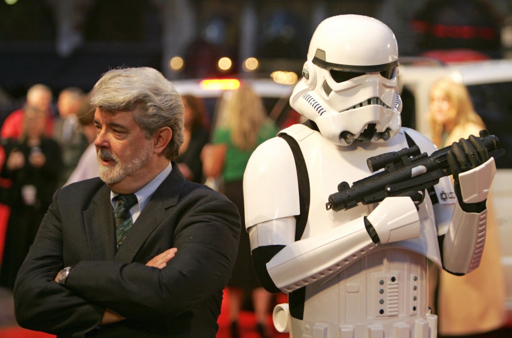 George Lucas and a Stormtrooper stand back to back