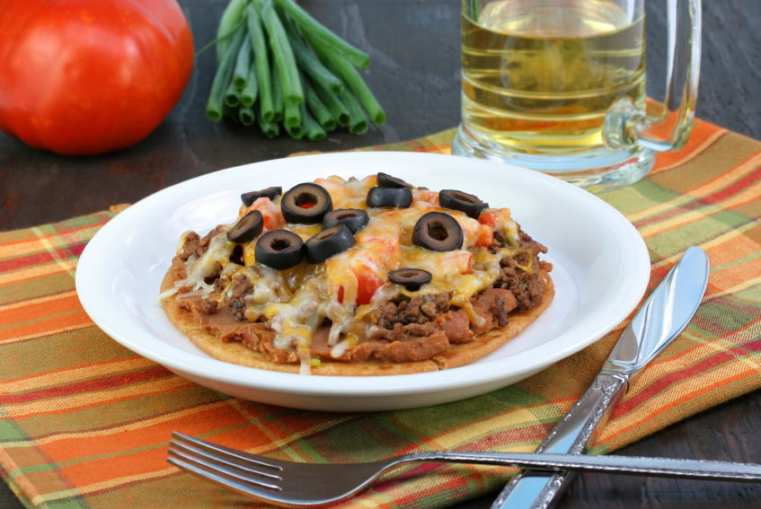 Mexican pizza with black olives, beef, and beans