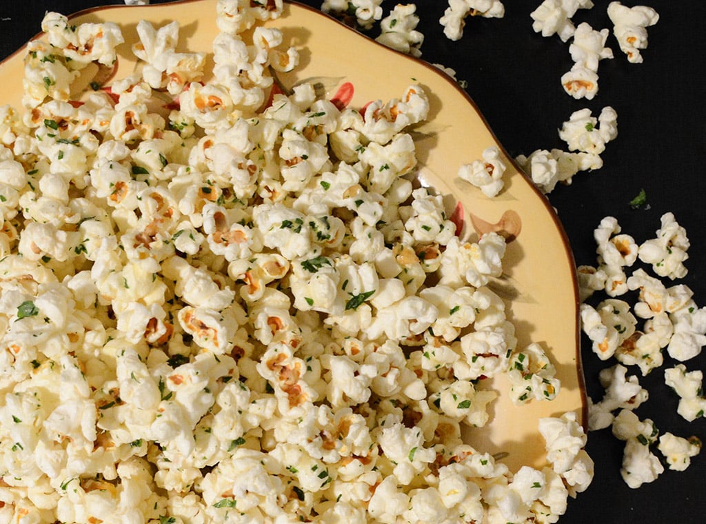 Garlic Parmesan Popcorn with Parsley in a yellow bowl