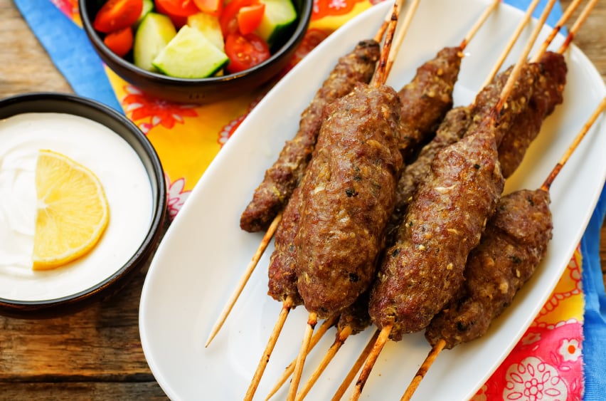 kebab skewers served in a white dish