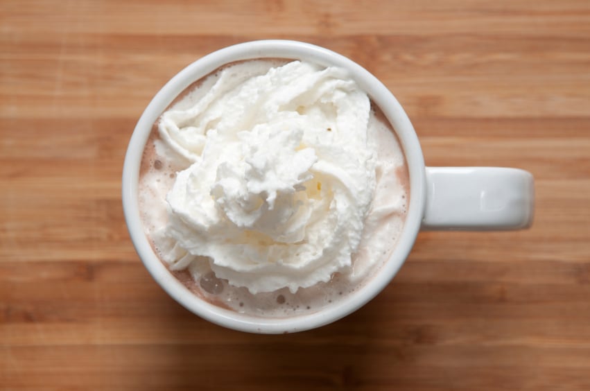 overhead view of a mug of hot chocolate with whipped cream