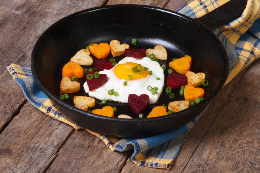 hash with heart-shaped carrots, potatoes, and beets with a fried egg
