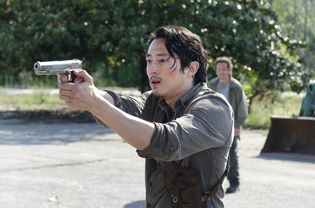 Glenn firing his gun to the left of the frame