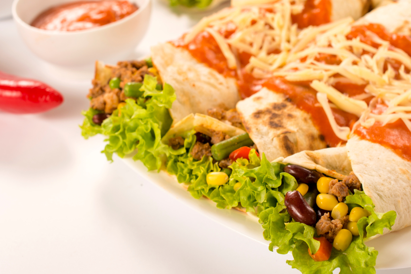 Enchiladas with fresh veggies, beans, and corn